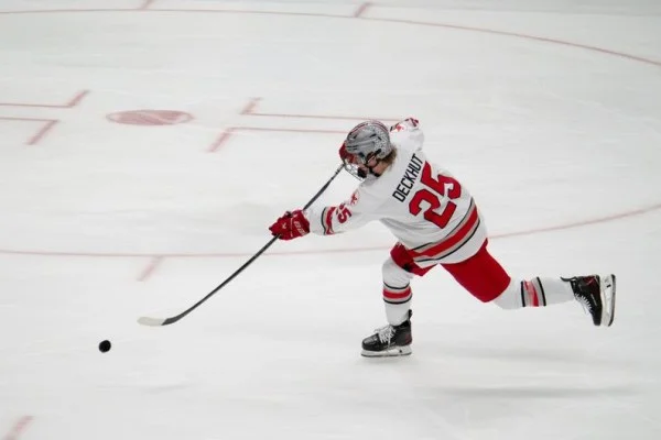 hockey player shooting puck